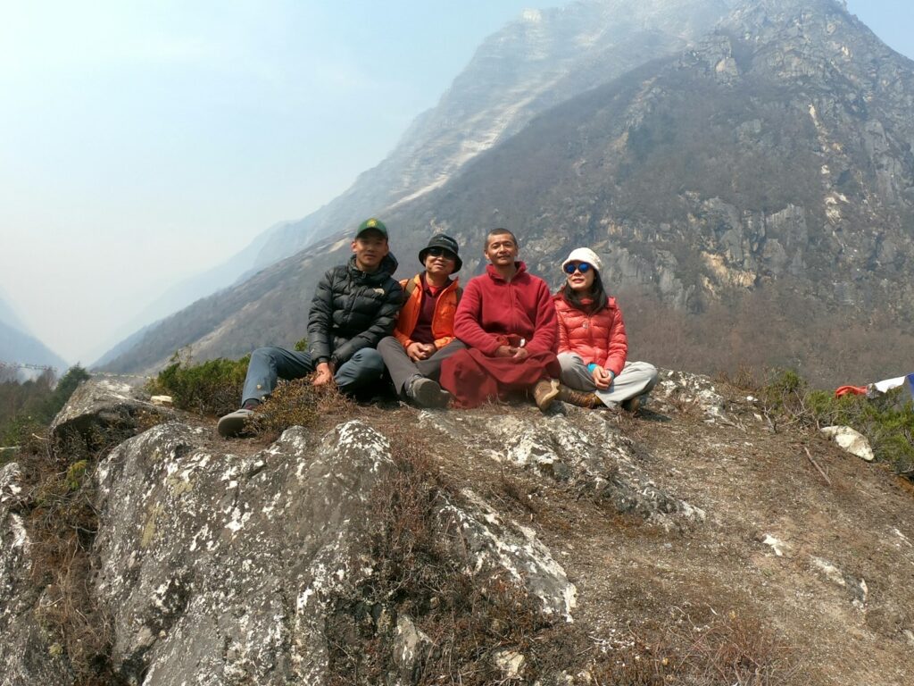 a group of people sitting on top of a mountain
