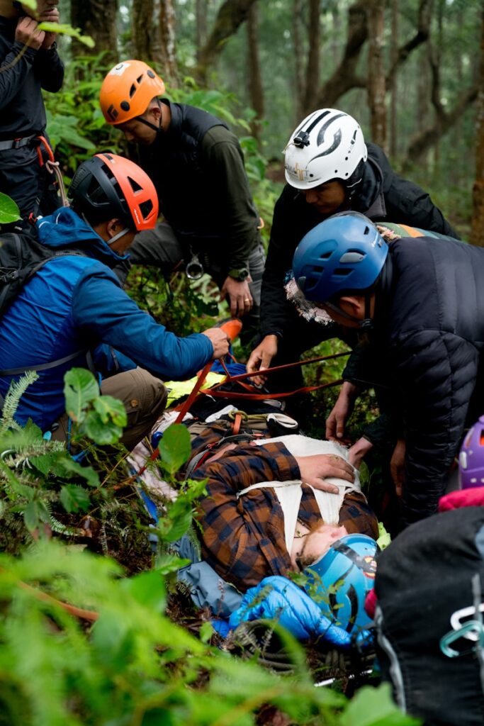 A group of people in the woods with helmets on
