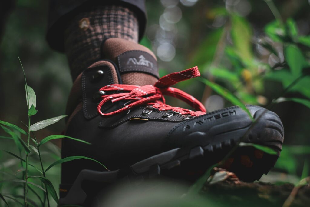 person wearing black and red nike athletic shoe